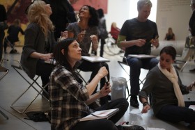 Group of people sitting in gallery and drawing