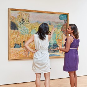 Two people looking at art in the gallery