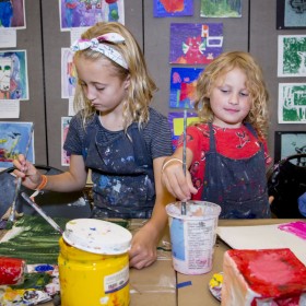 two children painting at table