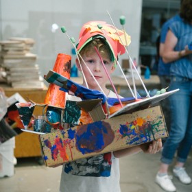 child holding paper craft