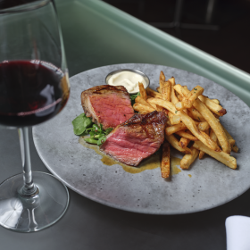 steak and fries with a glass of wine 