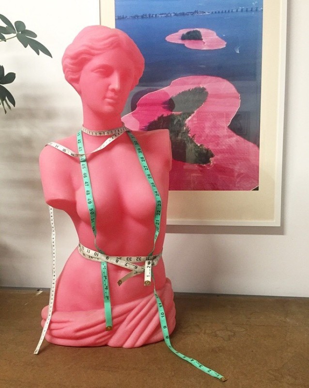 pink bust mannequin wrapped in measuring tape
