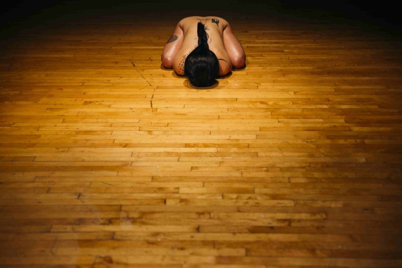 performer Daina Ashbee on a slated wooden floor