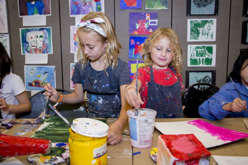 two children painting at table