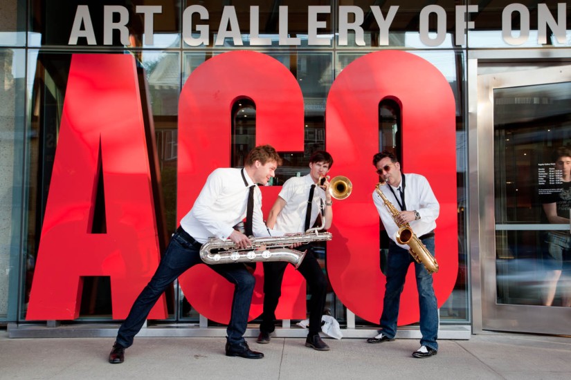Jazz players in front of red AGO letters at main entrance