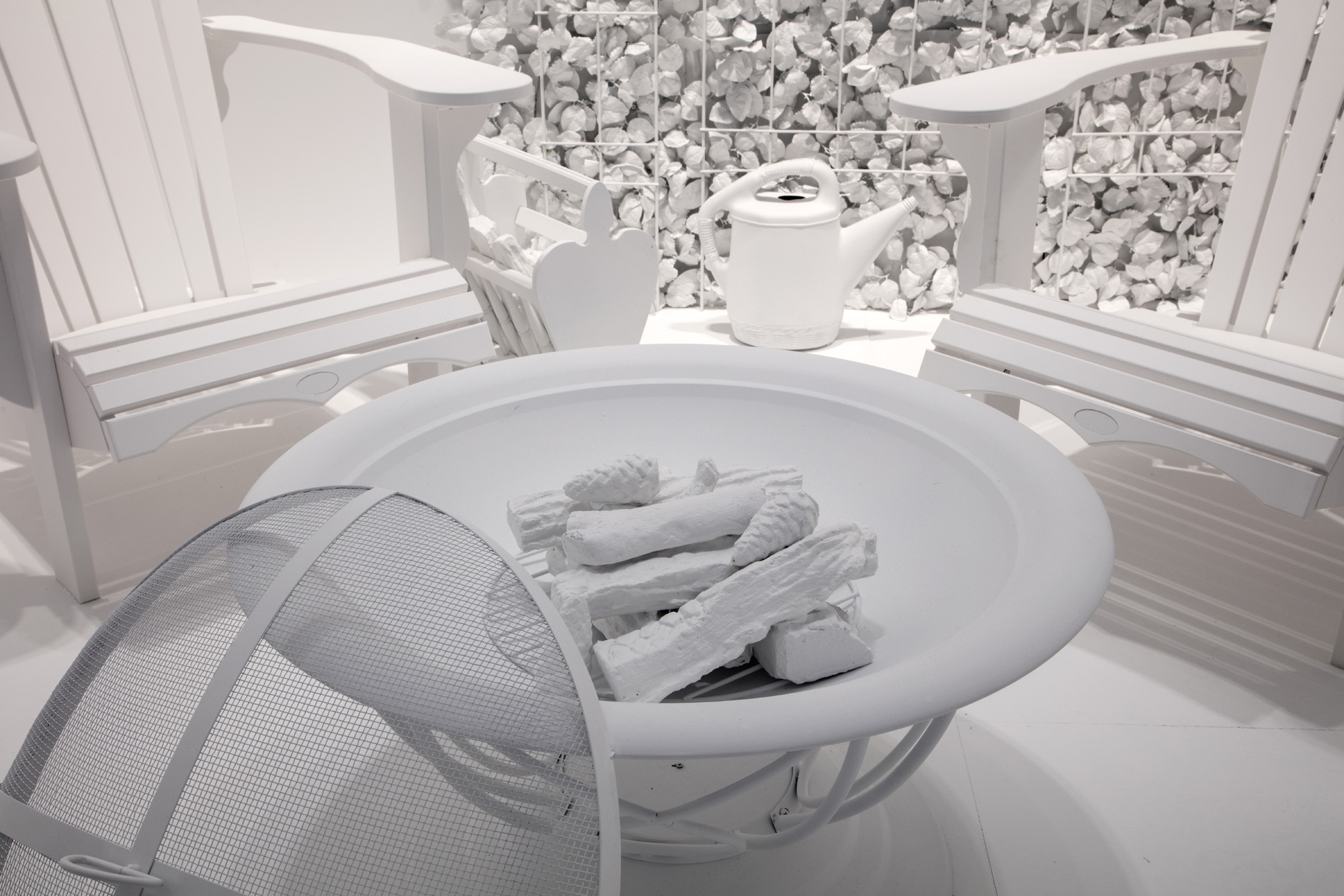 All white fire pit and Muskoka chairs in the AGO's The Obliteration Room