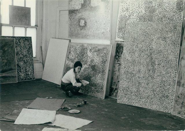 Yayoi Kusama with Infinity Net paintings in her New York studio