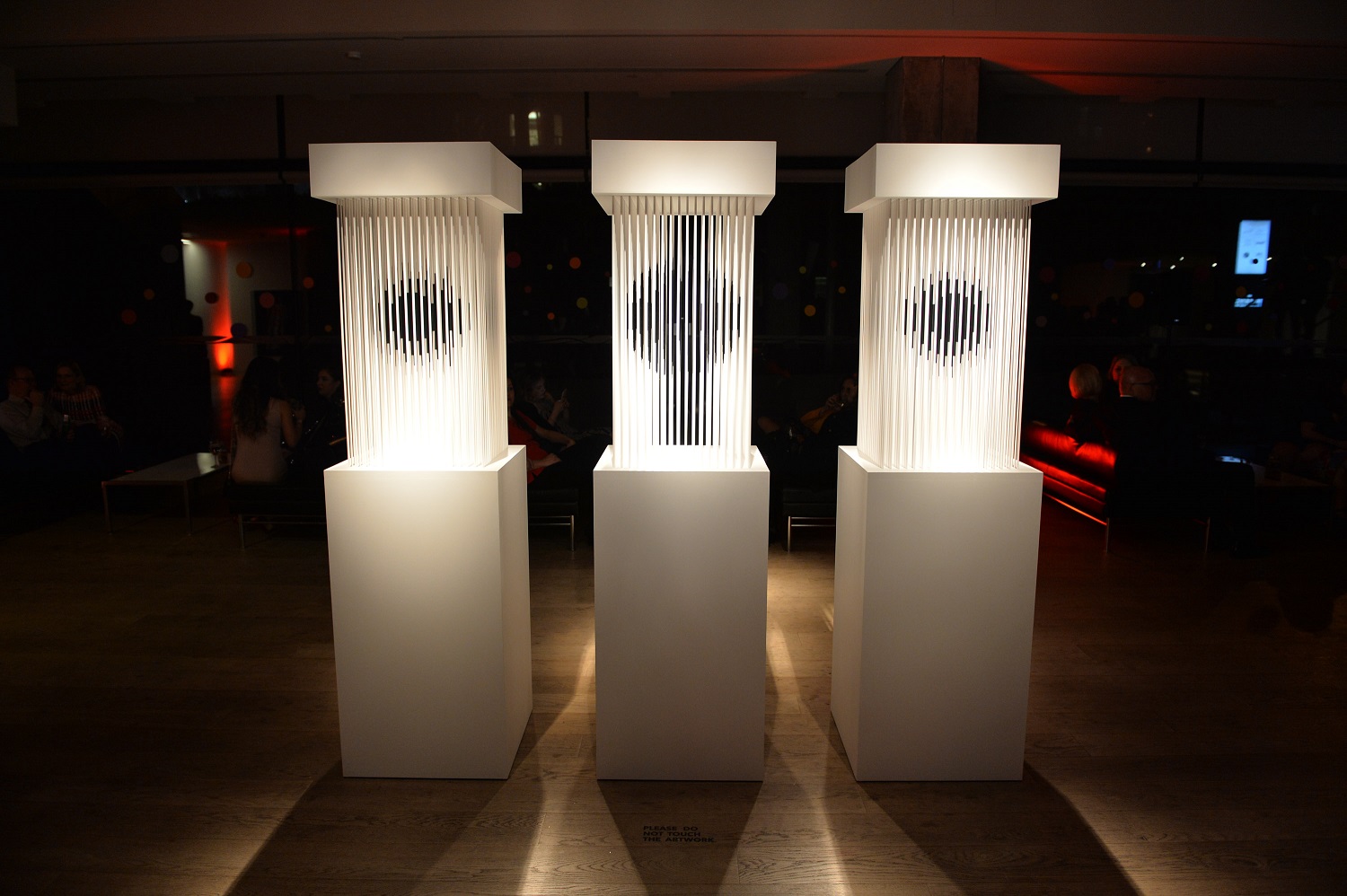 Three white pillars with strands that form three different spherical shapes by artist Jonathon R. Anderson.