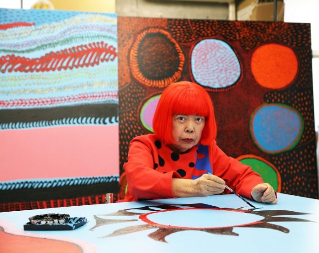 Portait of Yayoi Kusama in front of her works