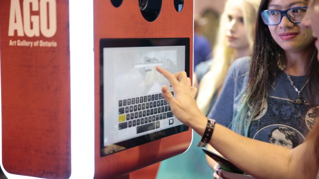 Women signing into a kiosk screen