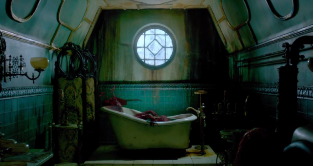 A person laying in a Victorian bath tub