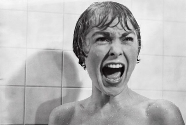A women screaming fearfully in a shower