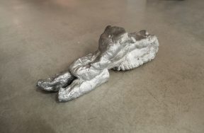 A silver sled sculpture.