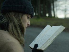 film still of girl reading
