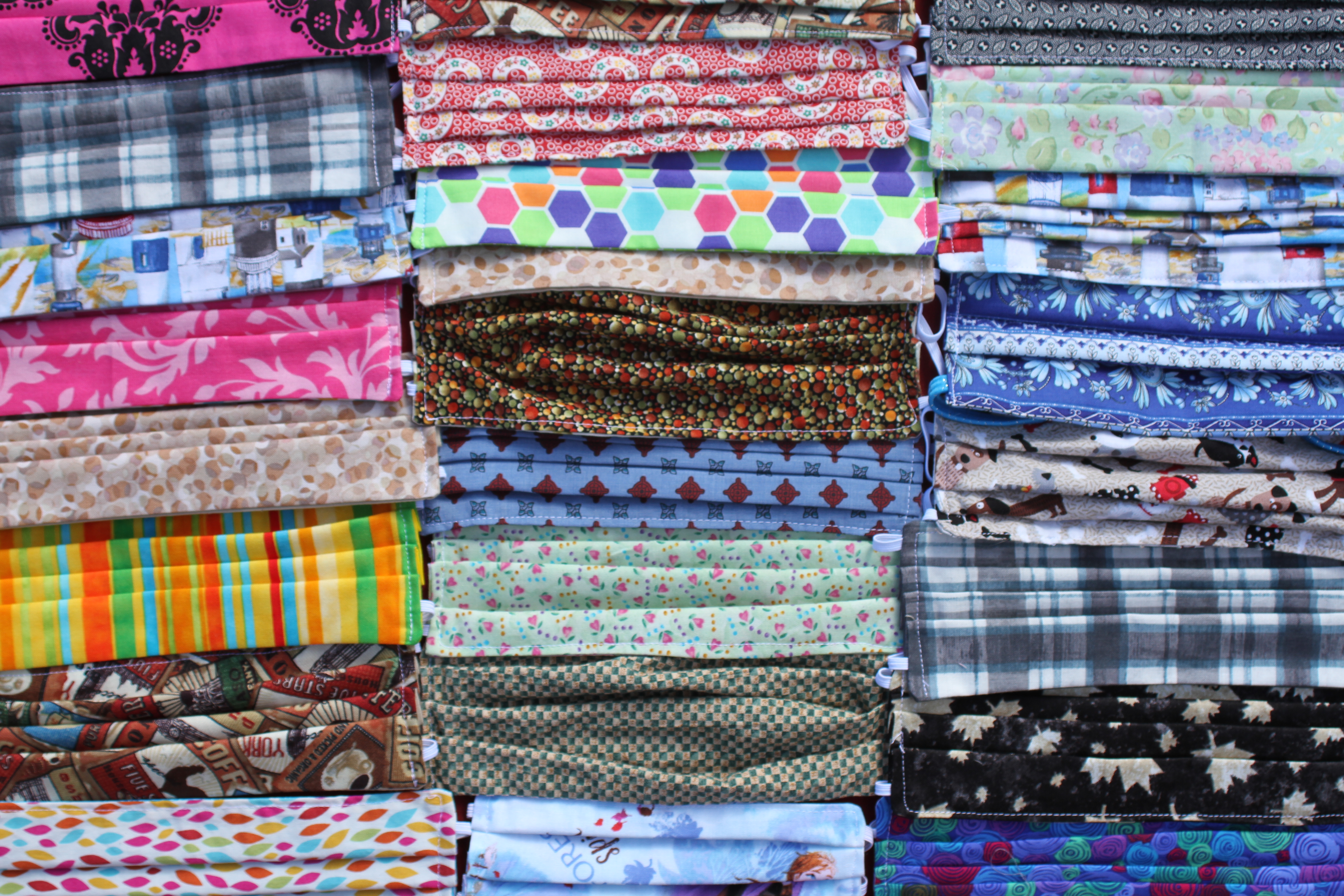 Photograph of colourful stacks of COVID face masks 