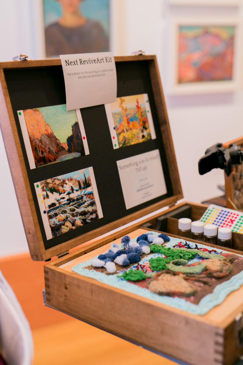 Suitcase with pictures of artwork, 3D artwork to touch, and containers with outdoor scents.