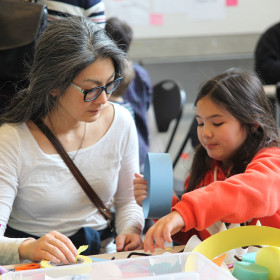 Girl and her mom making art