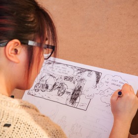 Student drawing a comic