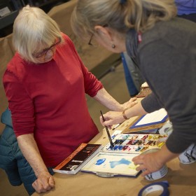 Instructor demonstrating watercolour technique