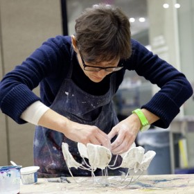 Adult working on sculpture 