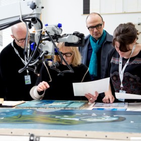 Conservation team and curators examining an artwork