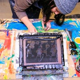 youth at printmaking easel