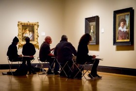 People drawing in front of paintings at the AGO