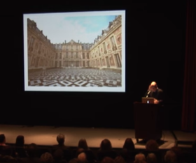 a person giving a lecture on a stage