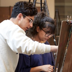 Two people at an easel