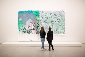 two people looking at art