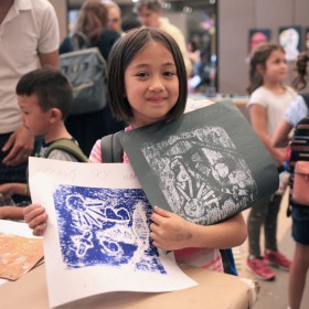 child holding a print 