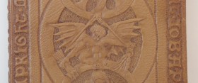 detail of the book of job, a leather bound and embossed figure with wings