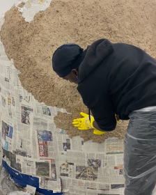 Oreka James making a papier mache sculpture
