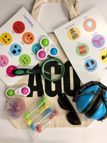 AGO tote bag and sensory kit items: sensory cards, magnifying glass, fidget toys, headphones, timers and sunglasses