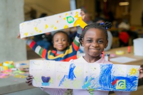 Children showing off their artwork