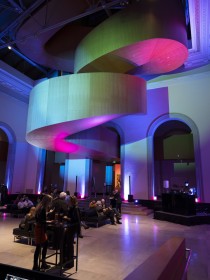 A shot of Walker Court within the AGO, with the signature staircase lit up with blue, purple and red lights