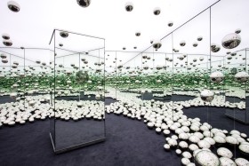 Interior of mirrored installation with silver orbs