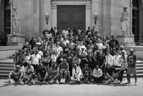 A black and white photo of Hip Hop artists in Toronto, standing on a staircase. 