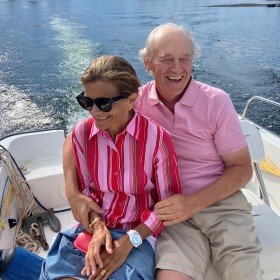 David and Robin Young sitting in motor boat on lake