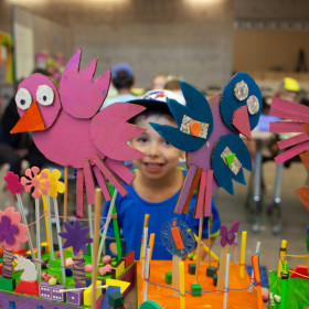 child with paper birds