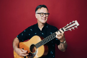 Man with glasses and a guitar