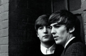 Black and white photo portrait of John Lennon and George Harrison 