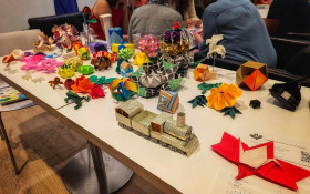 A variety of colourfully folded origami shapes of various sizes