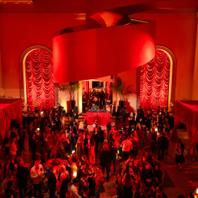 view from above, Art Bash guests in Walker Court decorated with drapes and table lamps
