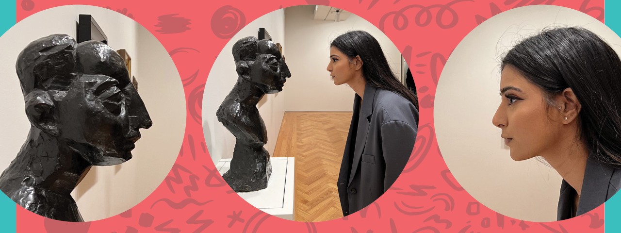 person looking at sculpture of a head