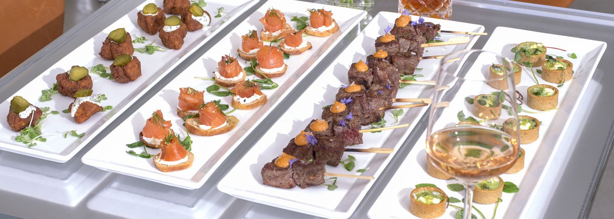 canapés on white long rectangular platters