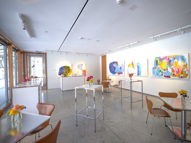 high and low tables with flowers in vases in AGO Art Social room