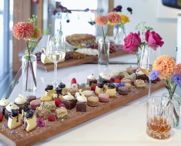 dessert platter surronded by flowers in vases