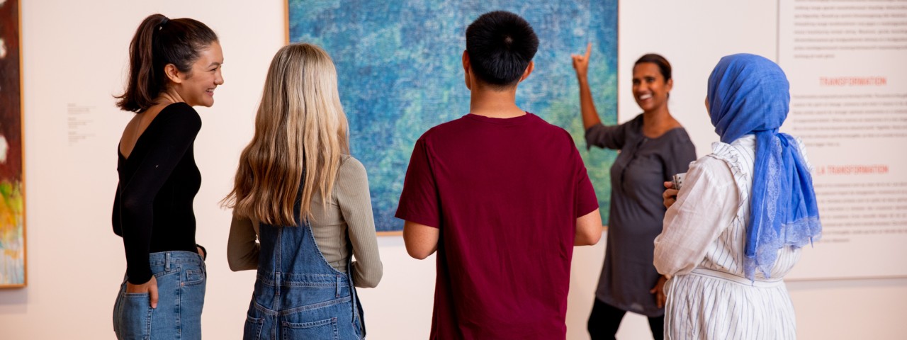 students looking at art with art educator