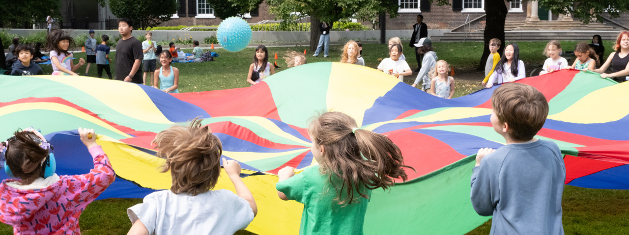 children holding parachute outdoors in Grange Park